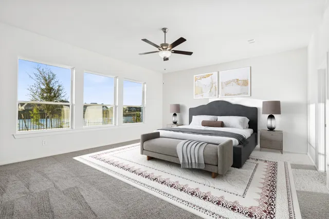 a bedroom with a large bed and a window