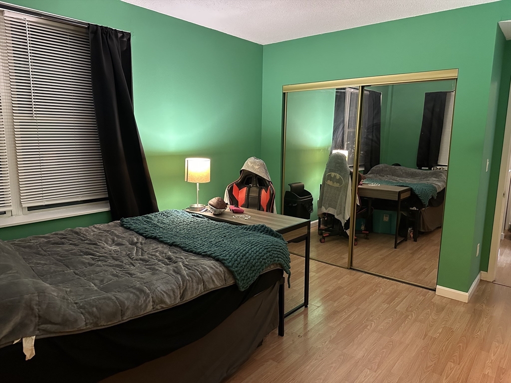 605 Eastern Avenue, Unit 211 Lynn, MA 01902 - Photo 14 of 29 a bedroom with a bed and a mirror on dresser