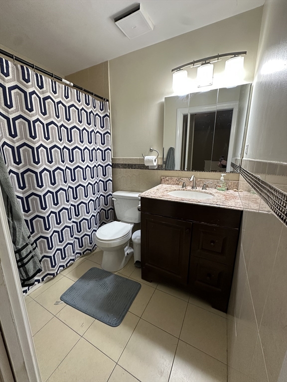 605 Eastern Avenue, Unit 211 Lynn, MA 01902 - Photo 18 of 29 a bathroom with a sink and a mirror