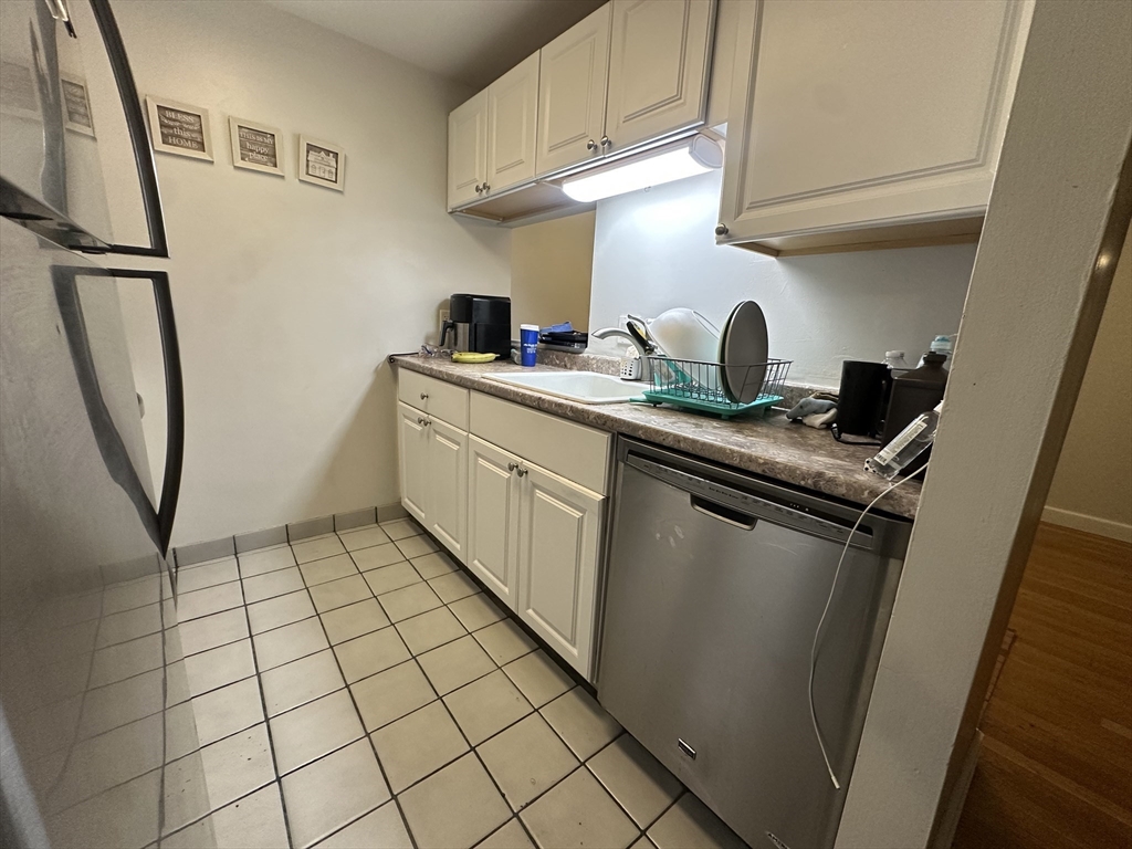 605 Eastern Avenue, Unit 211 Lynn, MA 01902 - Photo 7 of 29 a kitchen with stainless steel appliances granite countertop a stove a sink and a refrigerator