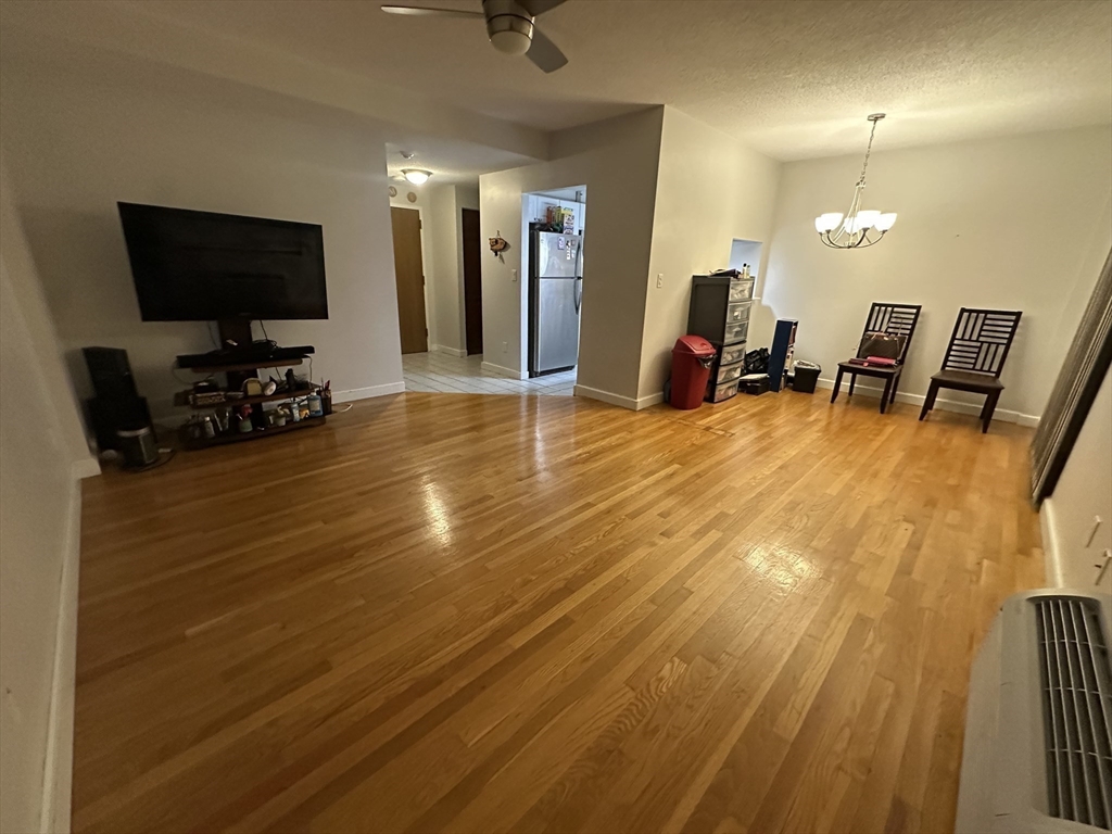 605 Eastern Avenue, Unit 211 Lynn, MA 01902 - Photo 9 of 29 a view of a living room and a flat screen tv