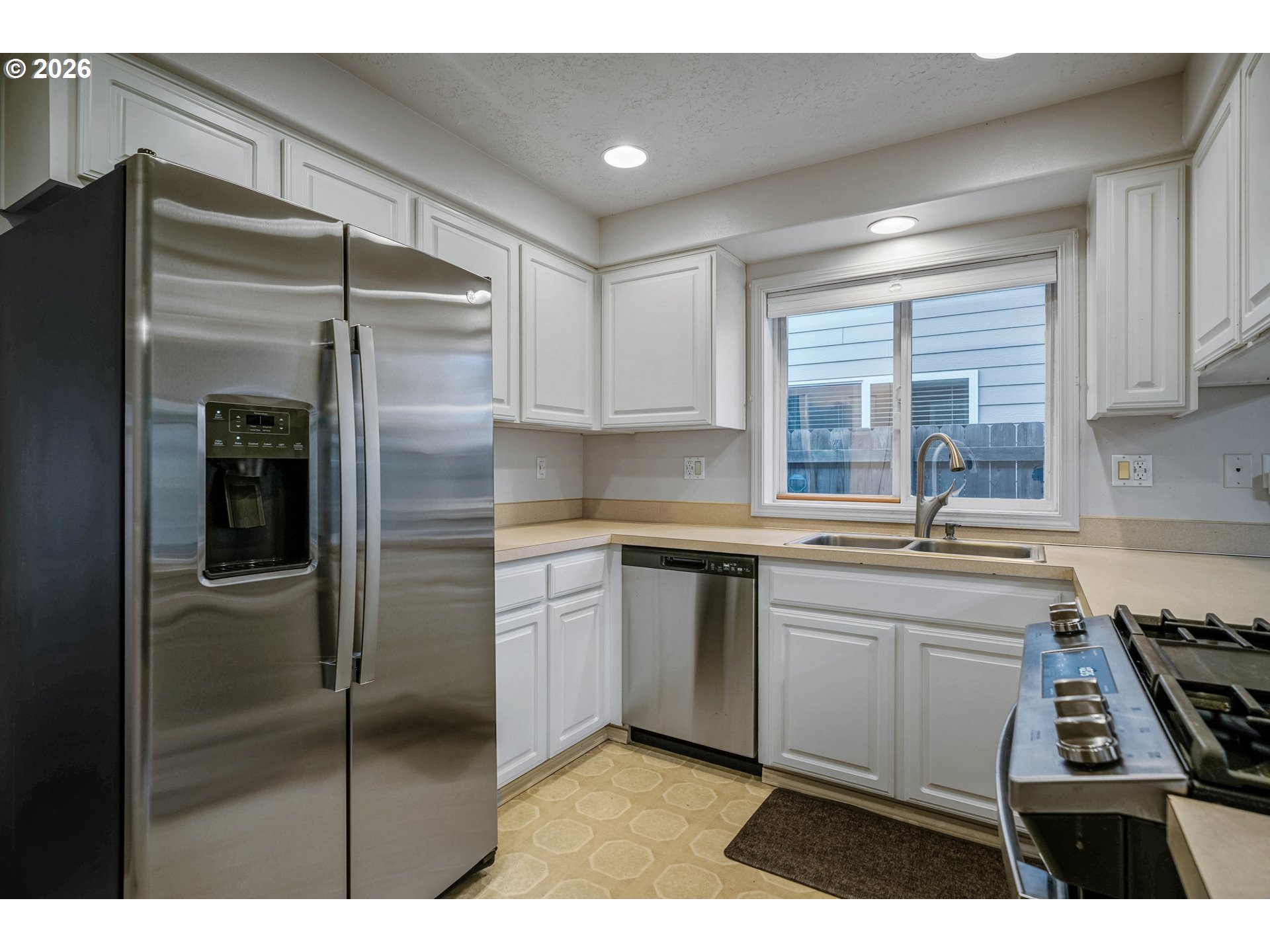 959 Stonebridge Avenue Northeast Keizer, OR 97303 - Photo 11 of 48 a kitchen with stainless steel appliances granite countertop a refrigerator and a sink