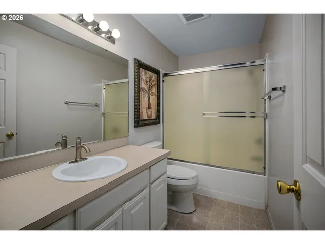 a bathroom with a sink toilet a mirror and shower