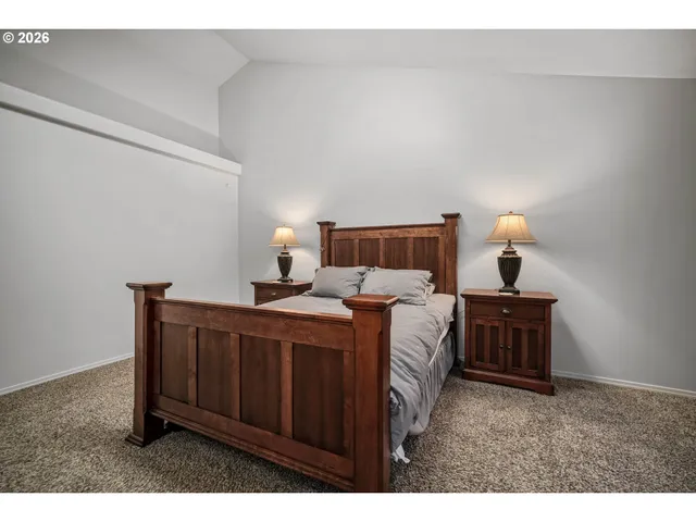 a bedroom with a bed and a lamp