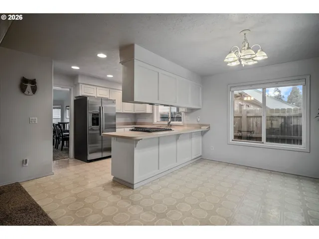 a kitchen with stainless steel appliances a sink stove and refrigerator