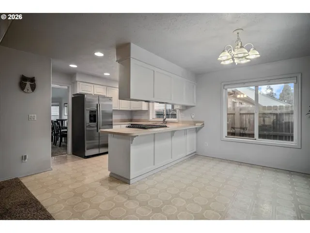 a kitchen with refrigerator and window