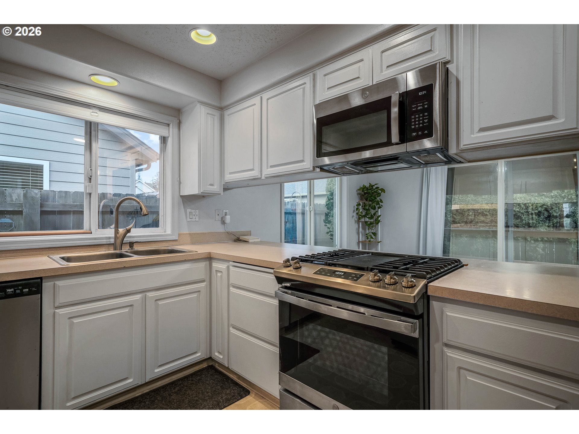 959 Stonebridge Avenue Northeast Keizer, OR 97303 - Photo 10 of 48 a kitchen with stainless steel appliances a sink dishwasher stove microwave and cabinets