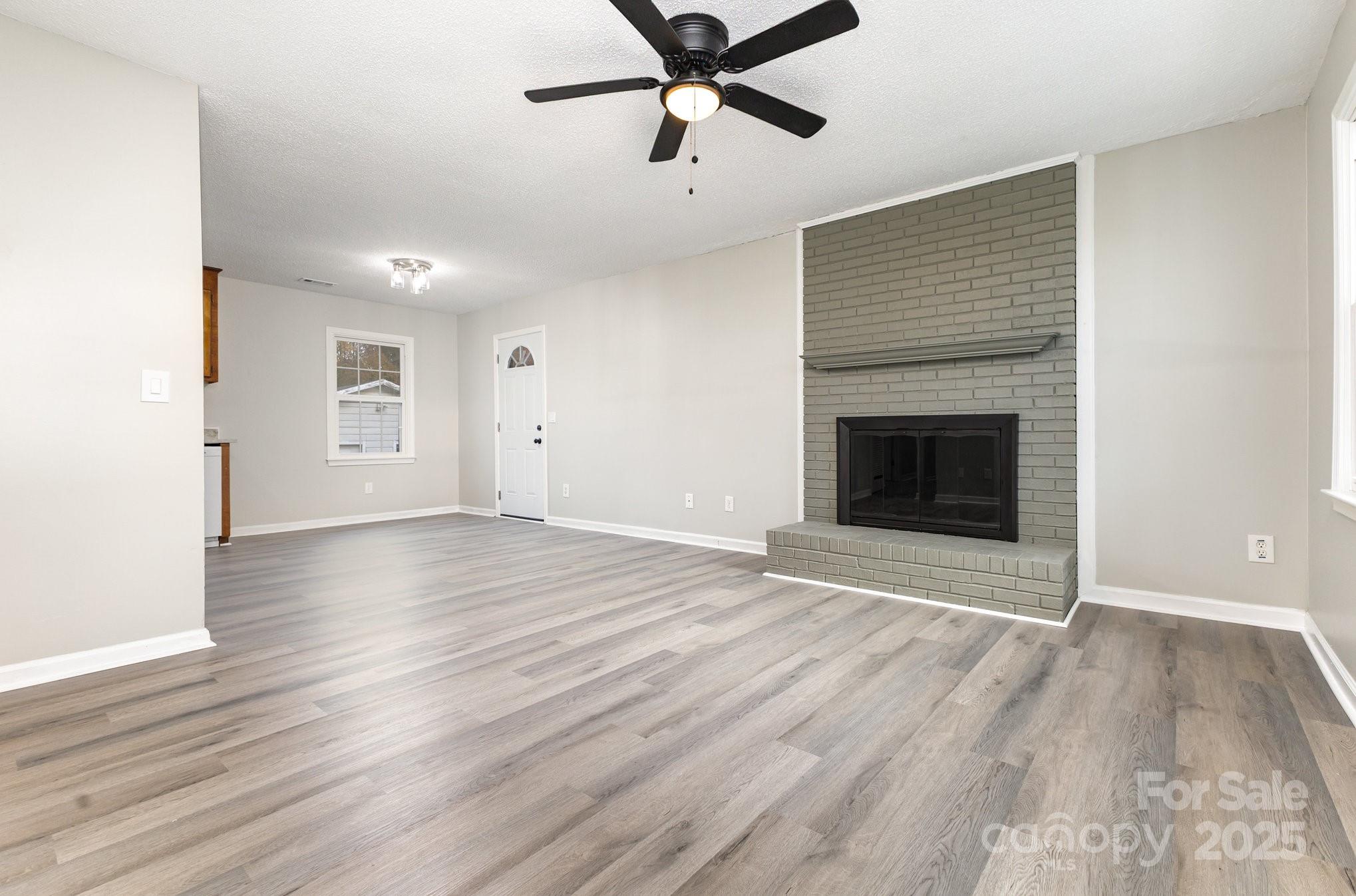 132 Hicks Road Grover, NC 28073 - Photo 11 of 31 a view of empty room with wooden floor and fireplace