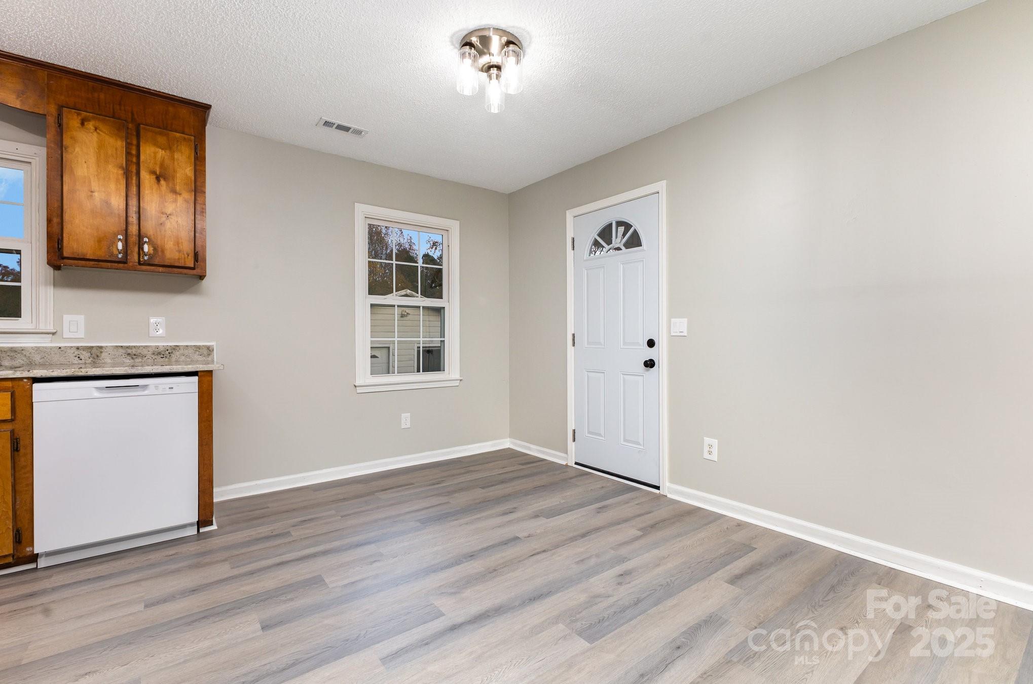 132 Hicks Road Grover, NC 28073 - Photo 14 of 31 an empty room with wooden floor and windows