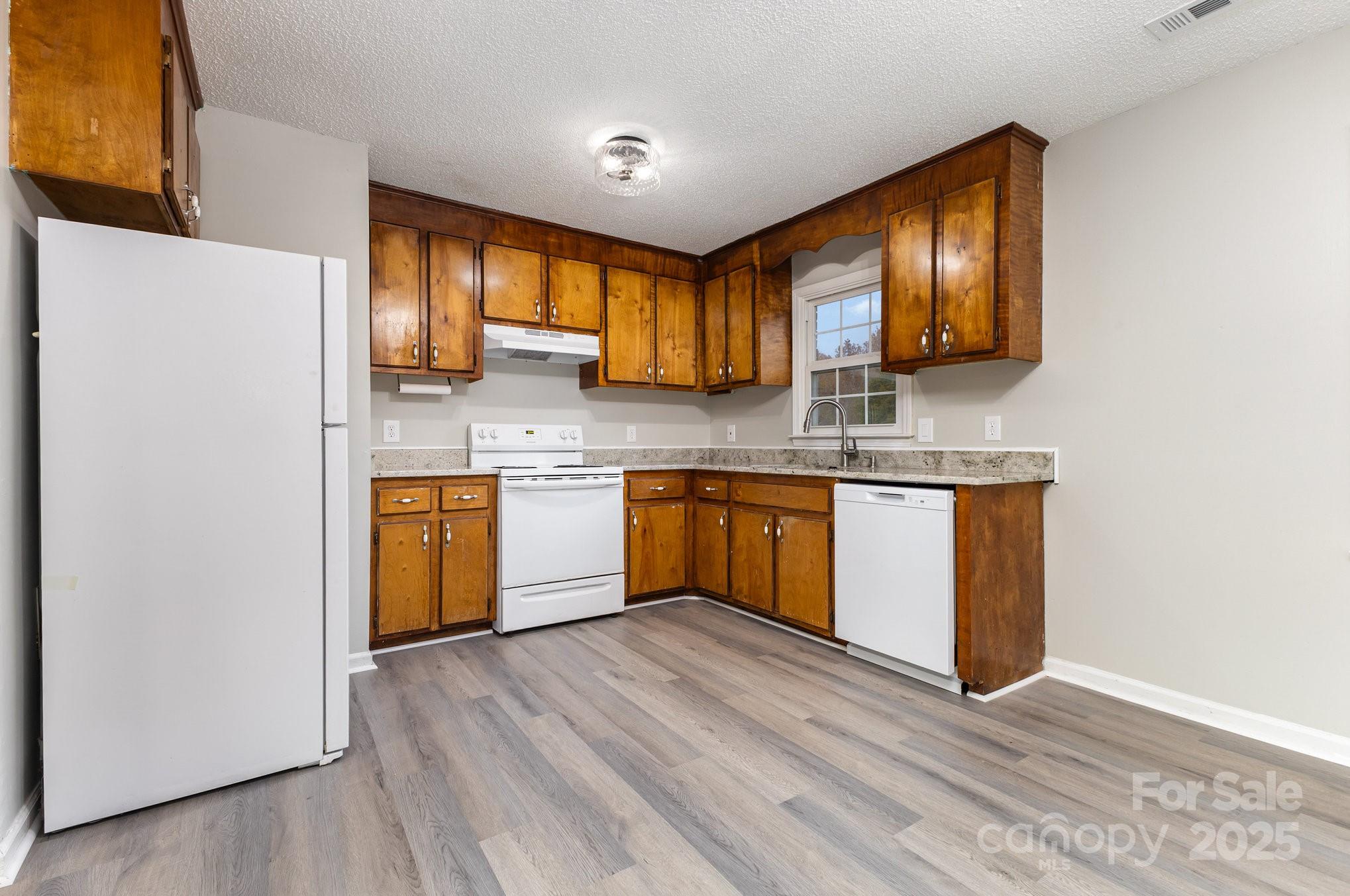 132 Hicks Road Grover, NC 28073 - Photo 15 of 31 a kitchen with stainless steel appliances granite countertop a stove cabinets and wooden floor