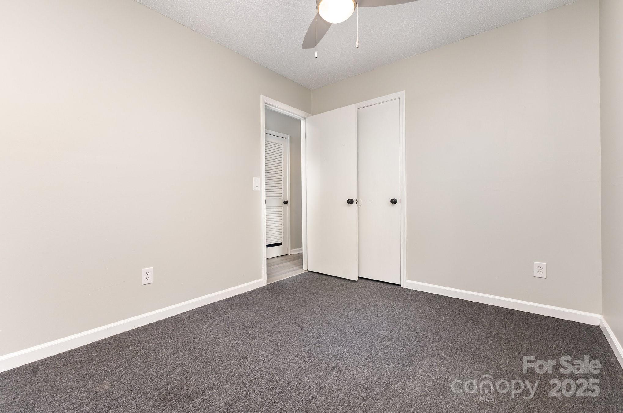 132 Hicks Road Grover, NC 28073 - Photo 29 of 31 an empty room with a ceiling fan and window