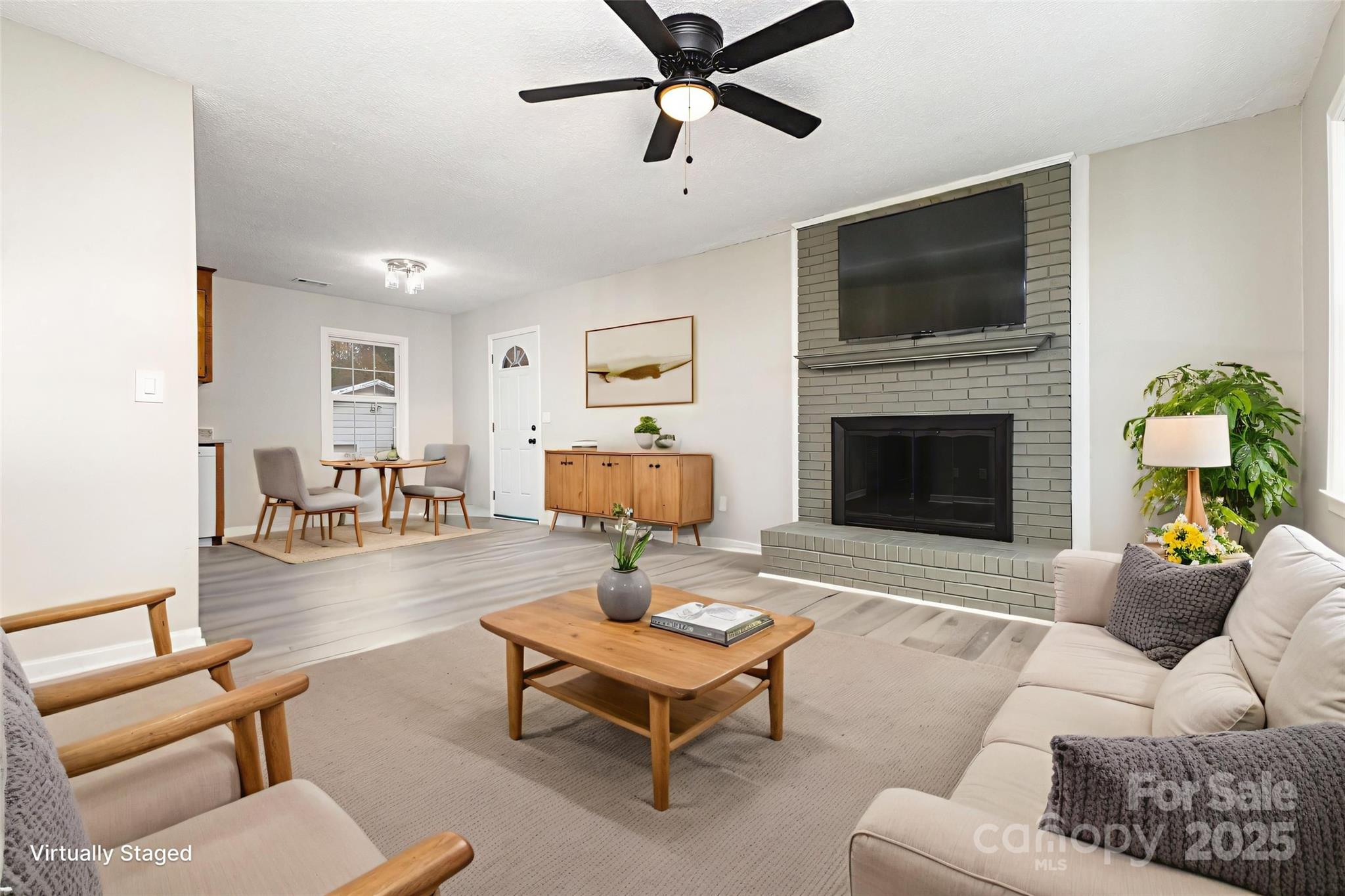 132 Hicks Road Grover, NC 28073 - Photo 10 of 31 a living room with furniture a fireplace and a flat screen tv