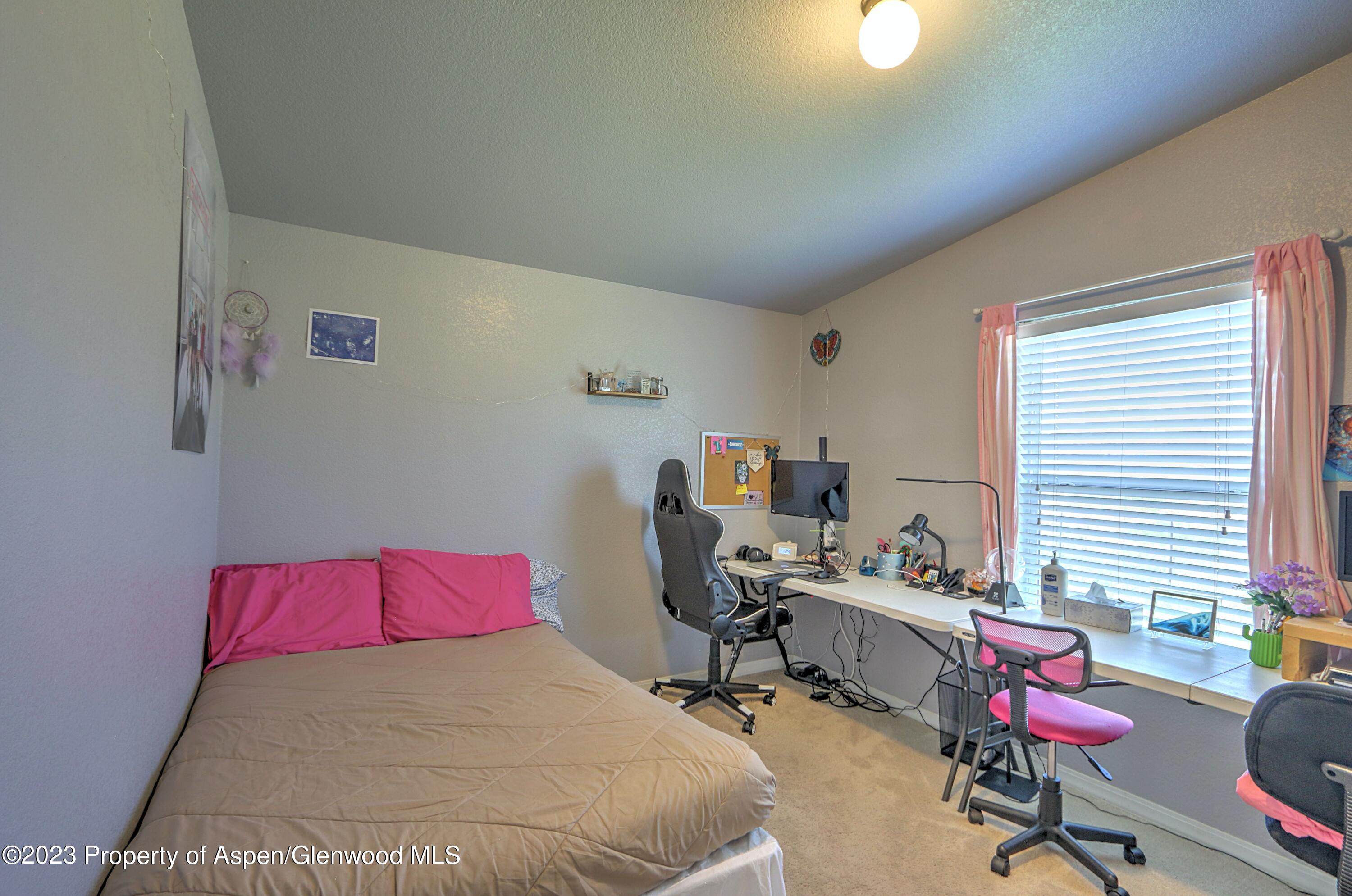 2517 210 County Road Rifle, CO 81650 - Photo 15 of 41 a bedroom with a bed chair and window