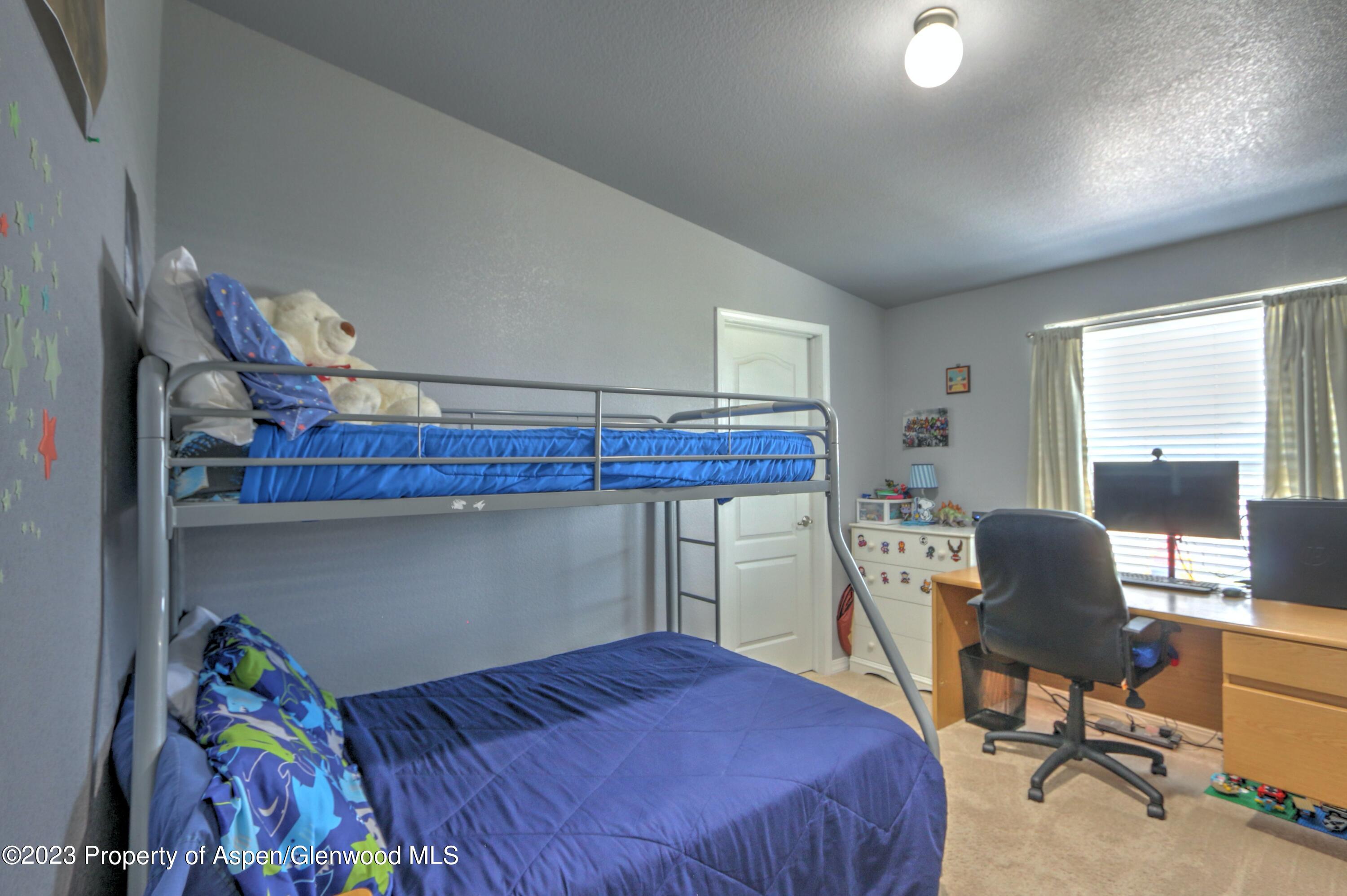 2517 210 County Road Rifle, CO 81650 - Photo 16 of 41 a bedroom with a bed and a window