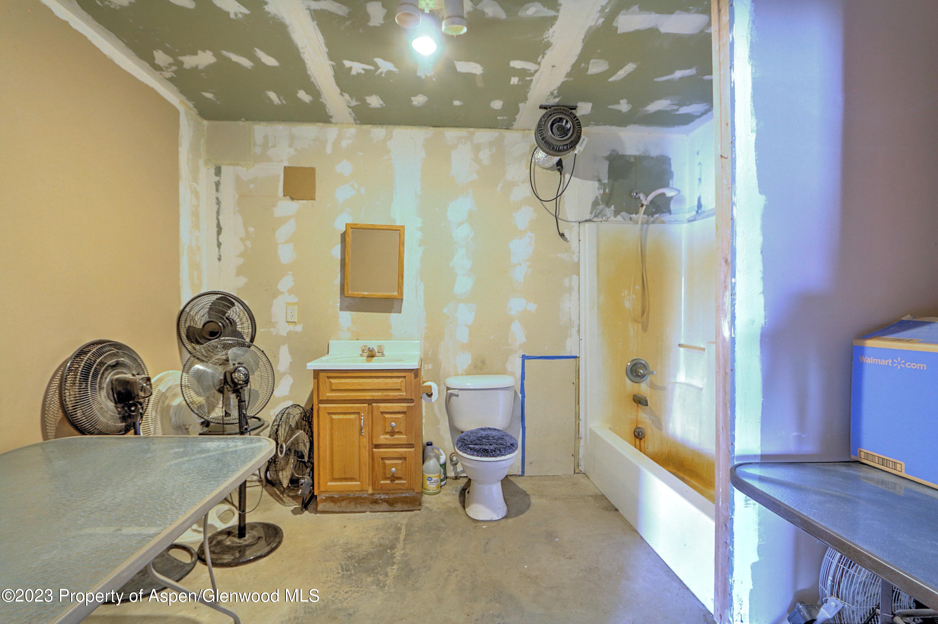 2517 210 County Road Rifle, CO 81650 - Photo 25 of 41 a bathroom with a sink a toilet and shower