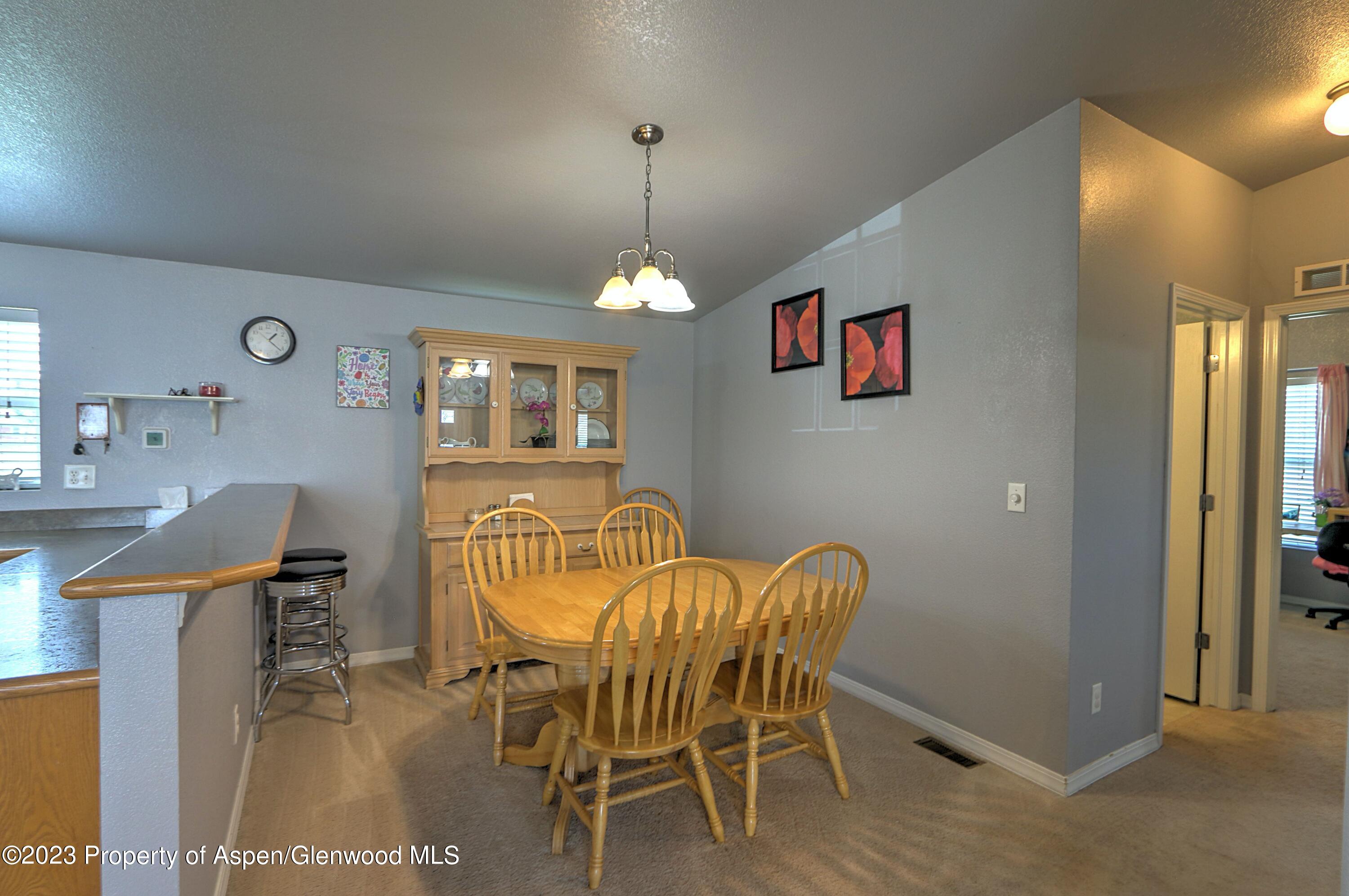 2517 210 County Road Rifle, CO 81650 - Photo 10 of 41 a view of a dining room with furniture and wooden floor