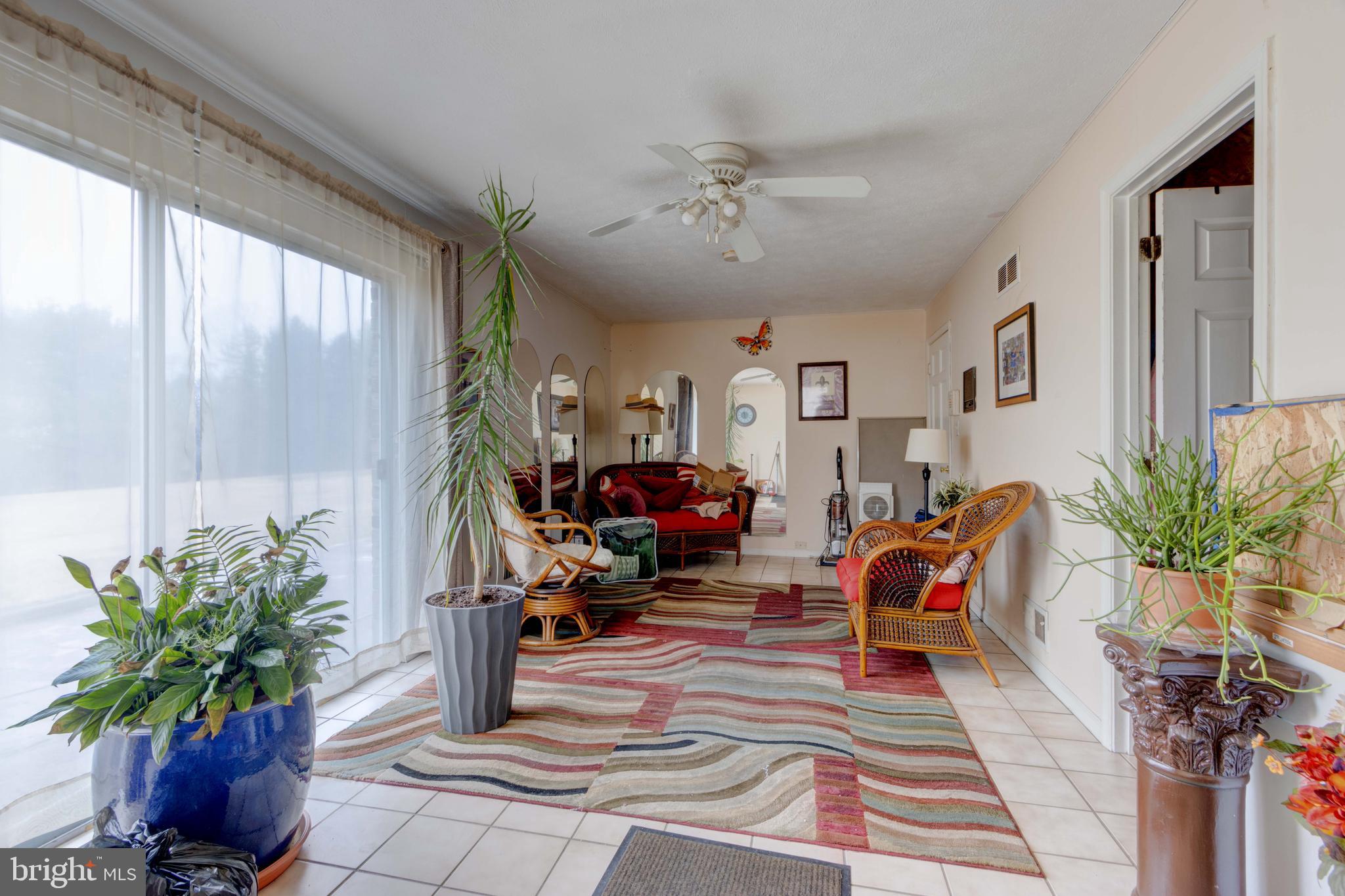 205 Glenville Road Churchville, MD 21028 - Photo 13 of 25 a living room filled with furniture and a potted plant