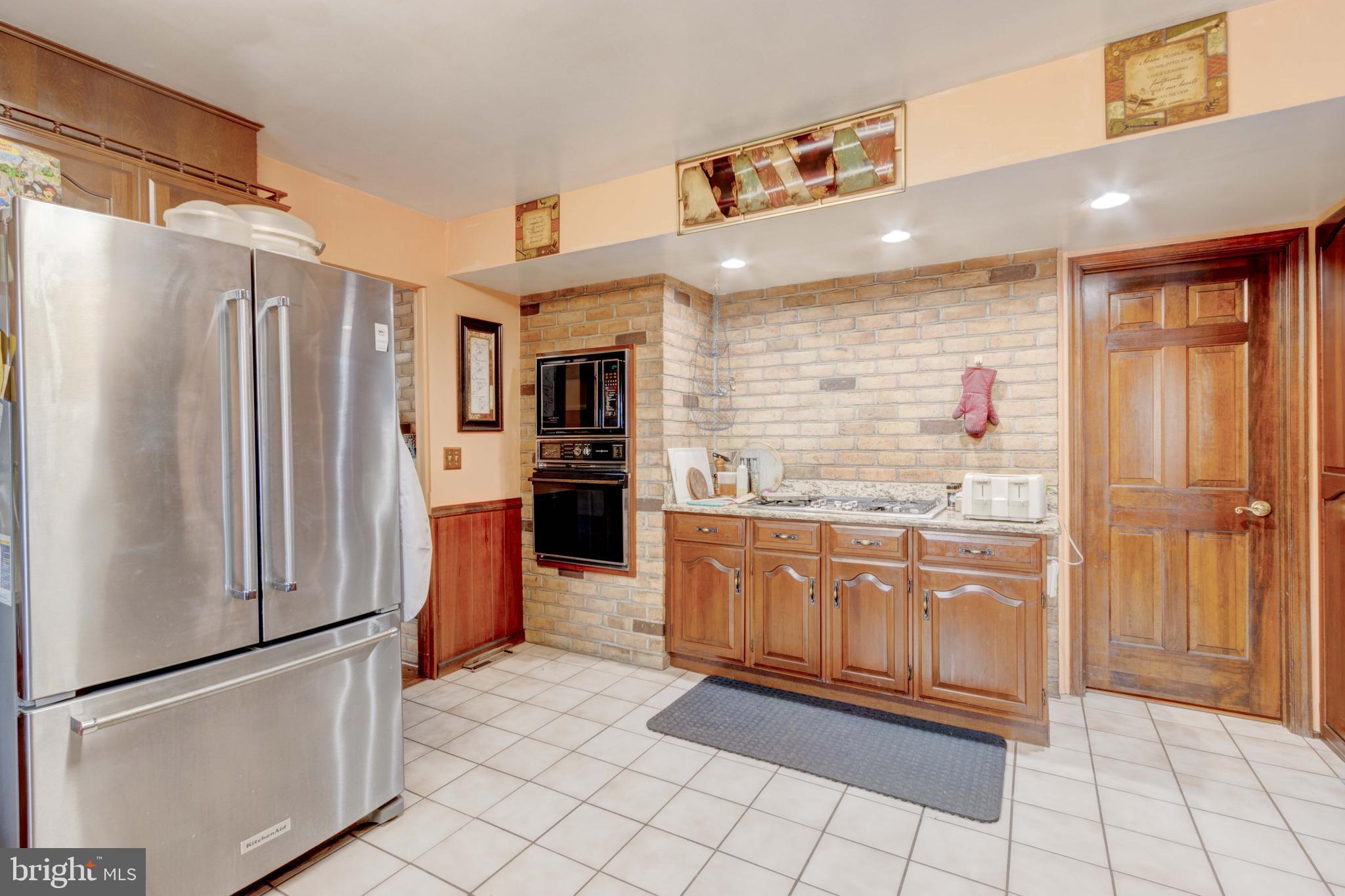 205 Glenville Road Churchville, MD 21028 - Photo 5 of 25 a kitchen with stainless steel appliances granite countertop a refrigerator and a sink