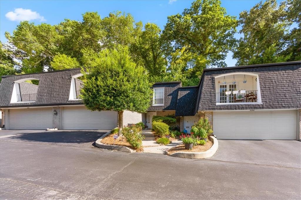 a front view of a house with a yard garage and outdoor seating