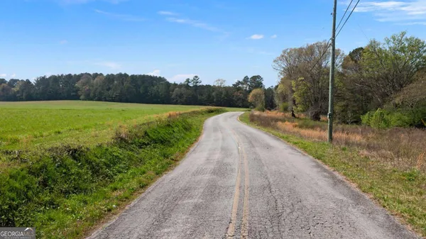 a view of a street with a yard