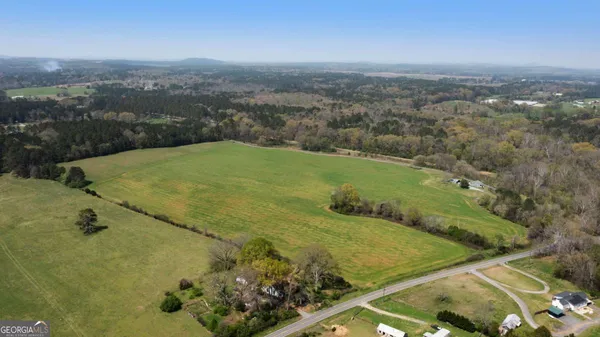 an aerial view of a golf course with parking space