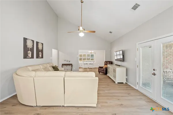 a living room with furniture and a wooden floor
