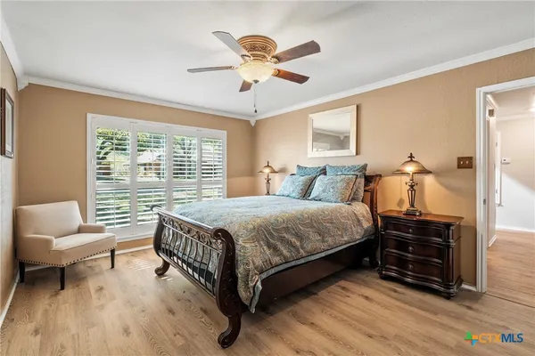 a bedroom with a bed a couch and a large window