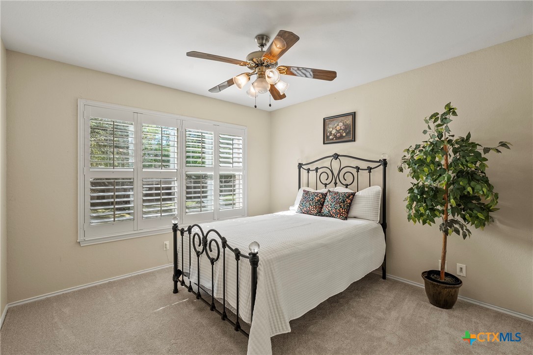 4518 Stagecoach Trail Temple, TX 76502 - Photo 22 of 29 a bedroom with a bed and a potted plant