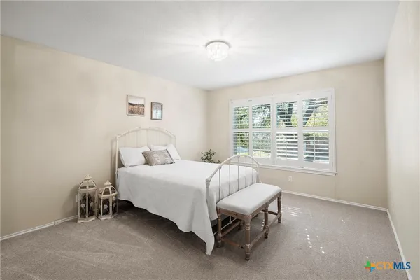 a bed room with a bed and a chair