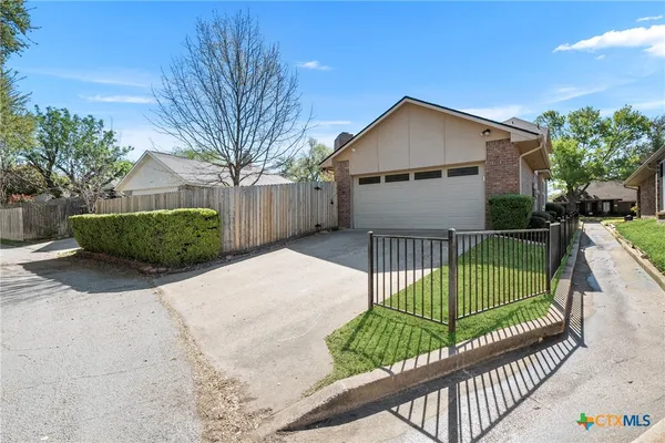 a view of a house with a small yard and plants