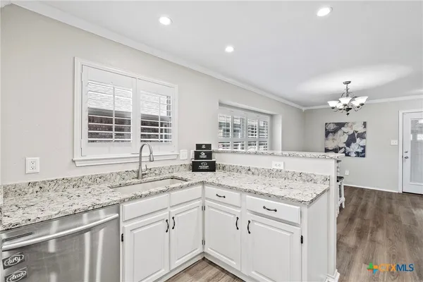 a kitchen with granite countertop a sink and a window