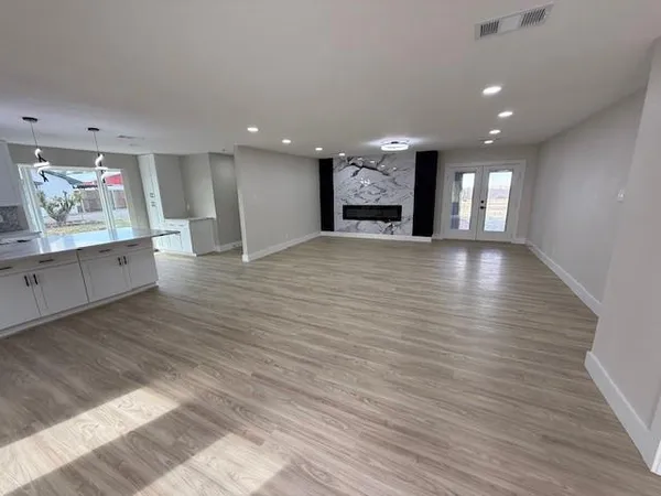 a view of large kitchen with a sink and wooden floor
