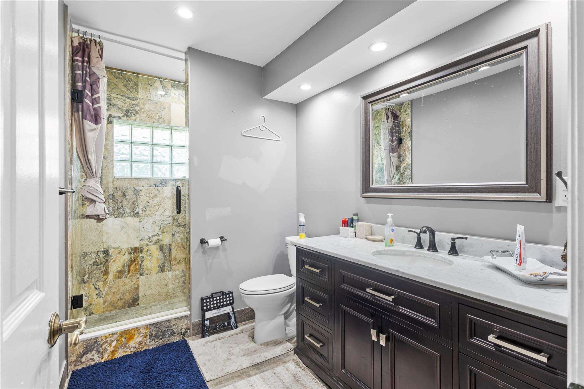 5223 Deerhurst Crescent Circle Boca Raton, FL 33486 - Photo 40 of 51 a bathroom with a sink toilet and shower