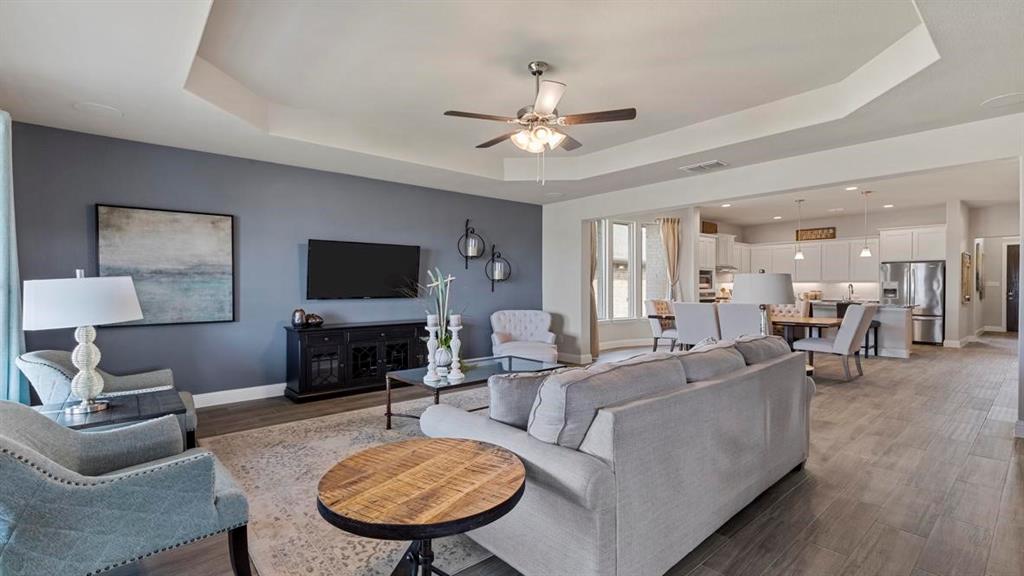 11205 Treehouse Trail Justin, TX 76247 - Photo 14 of 39 a living room with furniture a fireplace and a flat screen tv