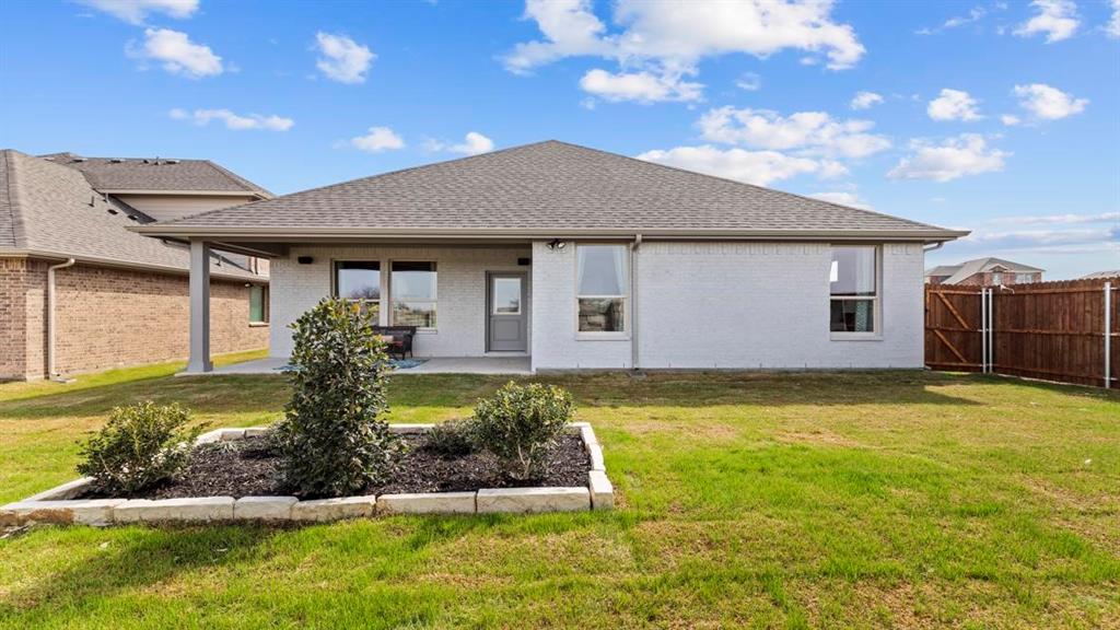 11205 Treehouse Trail Justin, TX 76247 - Photo 35 of 39 a front view of a house with garden