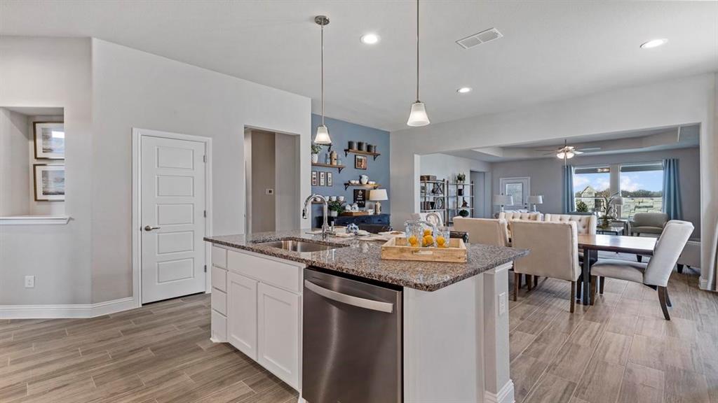 11205 Treehouse Trail Justin, TX 76247 - Photo 4 of 39 a room with stainless steel appliances granite countertop furniture wooden floor and a view of living room