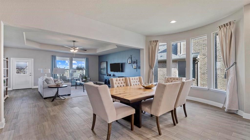 11205 Treehouse Trail Justin, TX 76247 - Photo 7 of 39 a view of a dining room with furniture and wooden floor