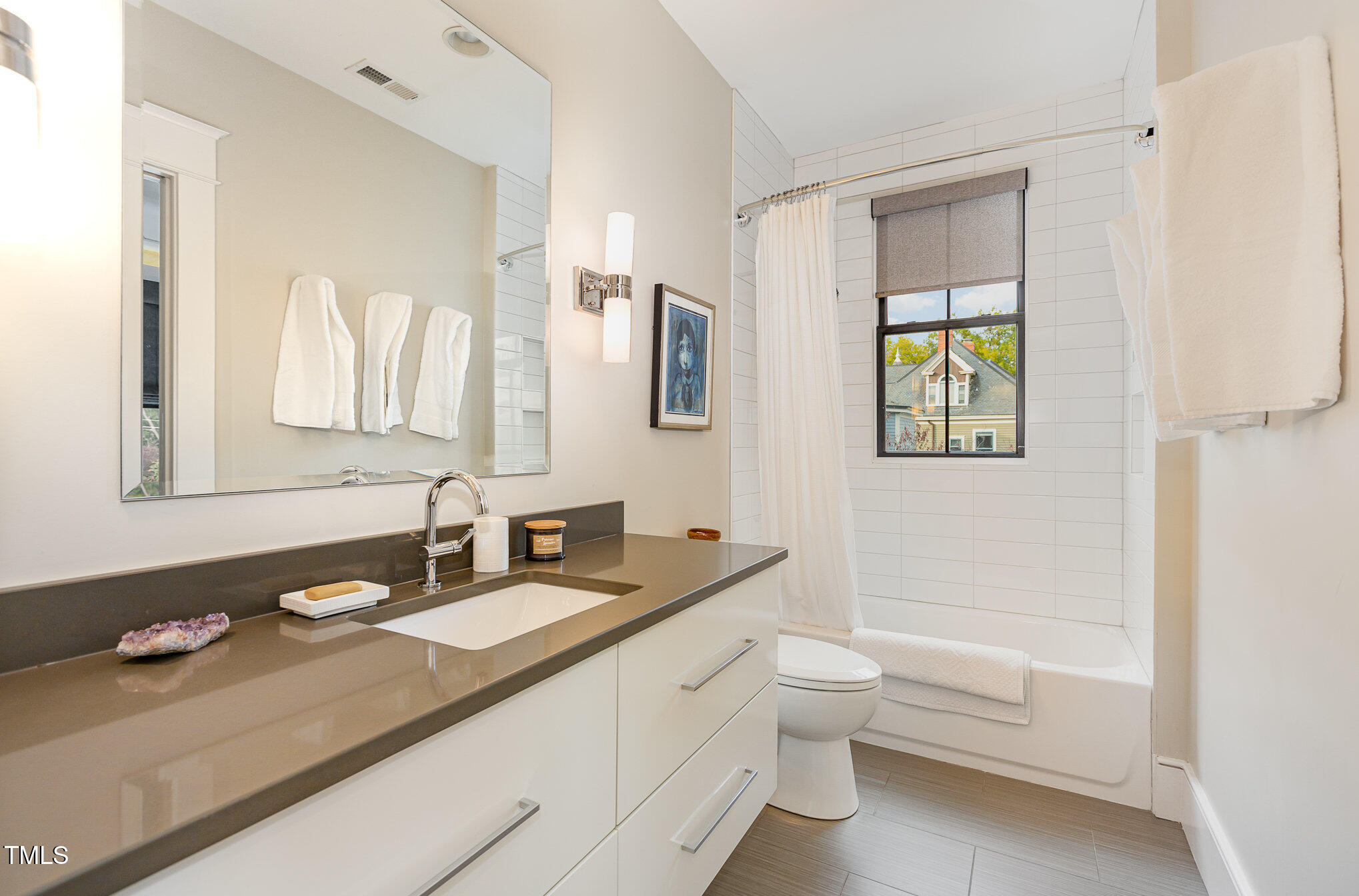 117 South Bloodworth Street Raleigh, NC 27601 - Photo 25 of 36 a bathroom with a granite countertop toilet sink and mirror