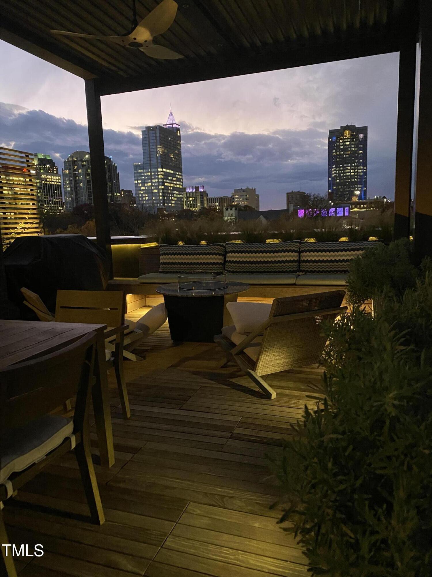 117 South Bloodworth Street Raleigh, NC 27601 - Photo 36 of 36 a terrace with outdoor seating and city view