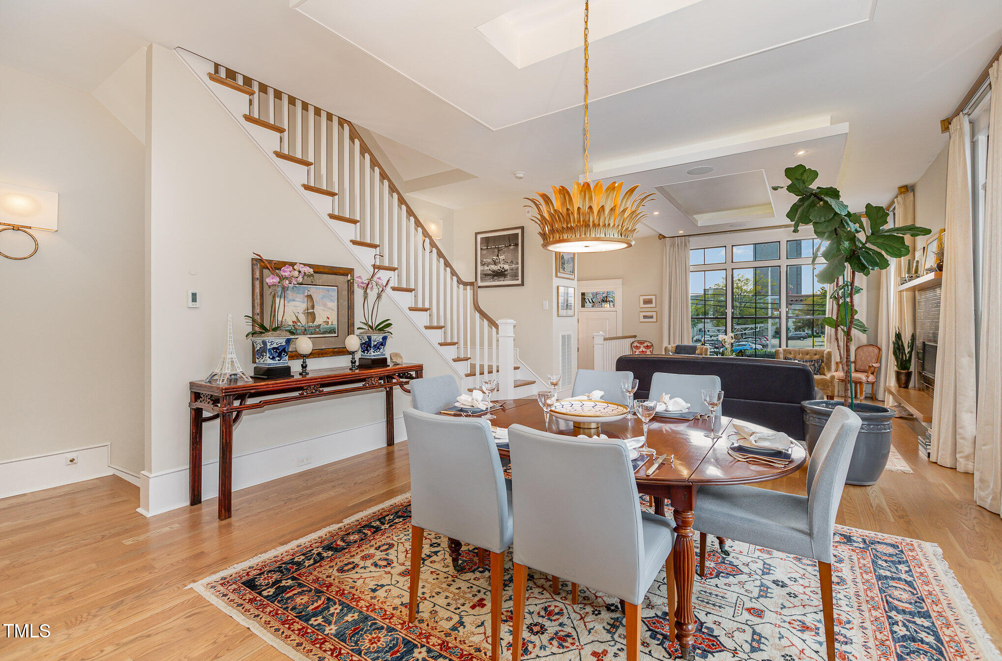 117 South Bloodworth Street Raleigh, NC 27601 - Photo 6 of 36 a living room with furniture a rug and a chandelier