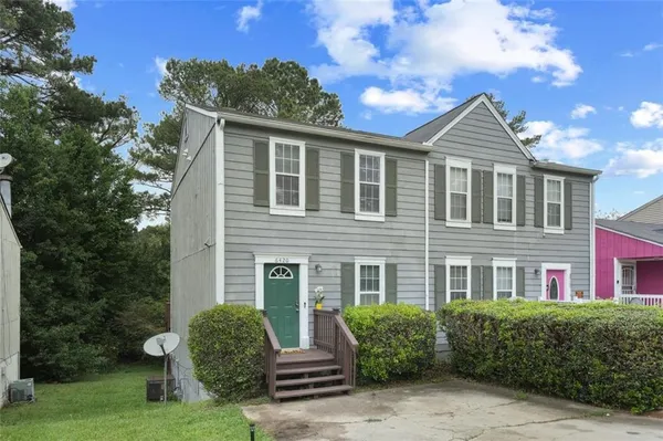 a front view of a house with garden
