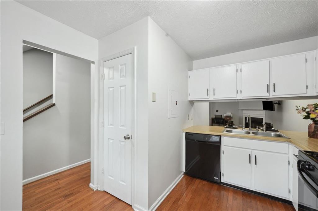 6420 Marbut Road Lithonia, GA 30058 - Photo 11 of 29 a view of a kitchen with white cabinets and wooden floor