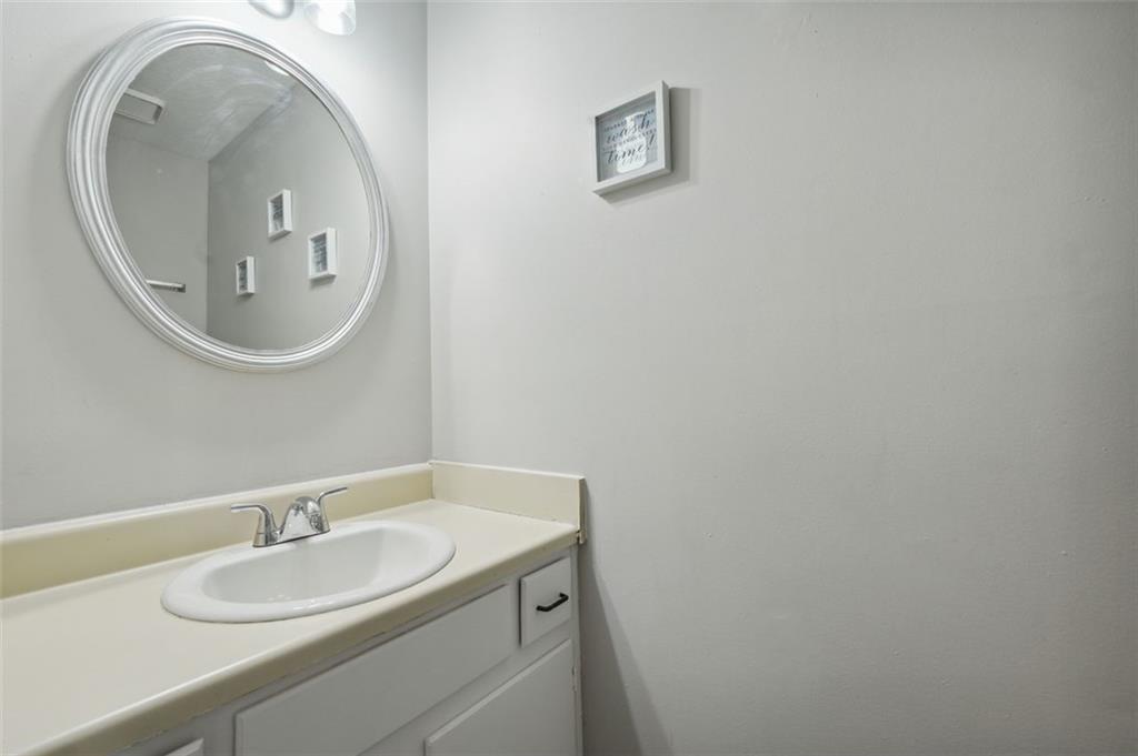 6420 Marbut Road Lithonia, GA 30058 - Photo 12 of 29 a bathroom with a granite countertop sink and a mirror