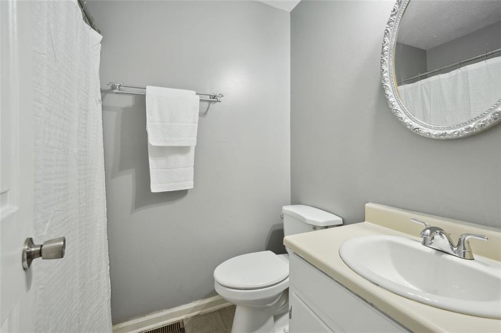 6420 Marbut Road Lithonia, GA 30058 - Photo 13 of 29 a white toilet sitting next to a bathroom sink
