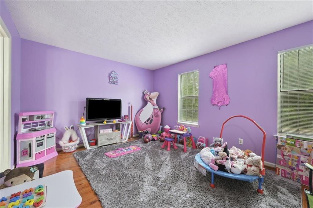 6420 Marbut Road Lithonia, GA 30058 - Photo 17 of 29 a living room with furniture and a flat screen tv