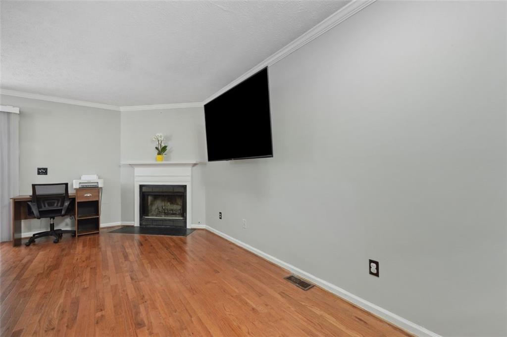6420 Marbut Road Lithonia, GA 30058 - Photo 6 of 29 a view of empty room with wooden floor and fireplace
