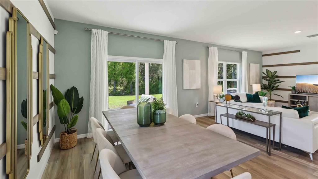 24478 Northwest 10th Road Newberry, FL 32669 - Photo 11 of 24 a living room with furniture large windows and wooden floor
