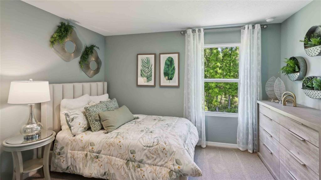 24478 Northwest 10th Road Newberry, FL 32669 - Photo 19 of 24 a bedroom with a bed and window with lamp