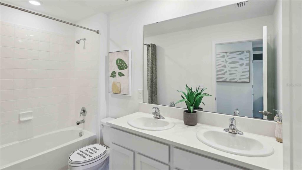 24478 Northwest 10th Road Newberry, FL 32669 - Photo 21 of 24 a bathroom with a granite countertop sink a toilet and shower