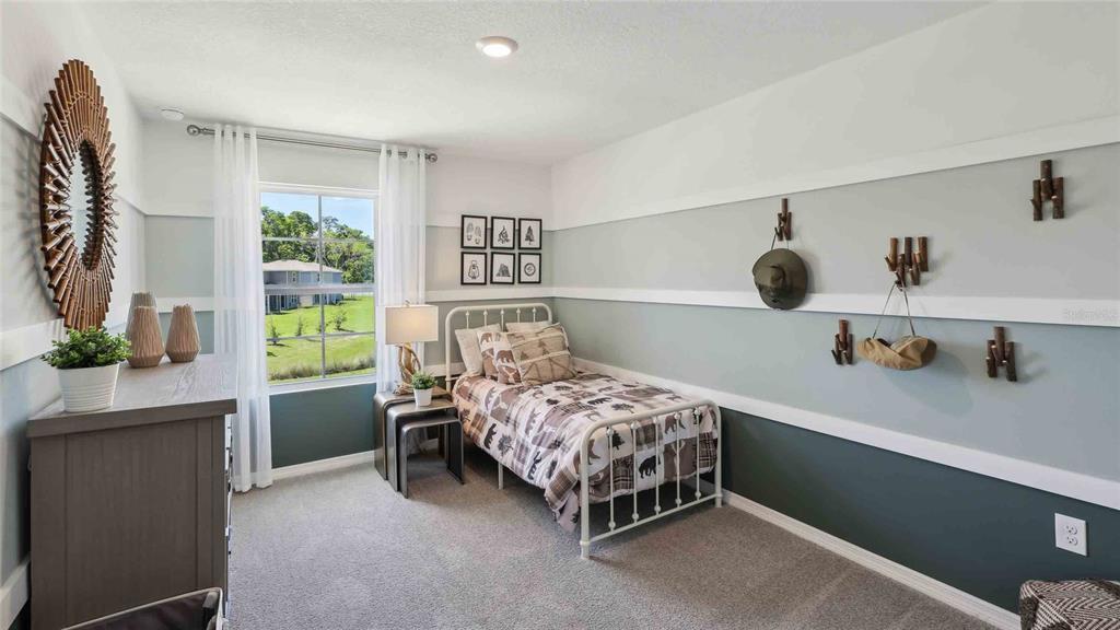 24478 Northwest 10th Road Newberry, FL 32669 - Photo 22 of 24 a bedroom with a bed and a table in it